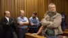 Some of the 20 right-wing extremists convicted of high treason for a plot to kill former South African president Nelson Mandela and drive blacks out of the country attend their trial at Pretoria High Court on Oct. 29, 2013.