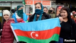People celebrate on the streets after Azerbaijan's President Ilham Aliyev said the country's forces had taken Shusha, which Armenians call Shushi, during the fighting over the breakaway region of Nagorno-Karabakh, in Baku, Nov. 8, 2020.