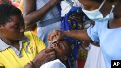FILE: A child receives a polio vaccine, during the Malawi Polio Vaccination Campaign Launch in Lilongwe Malawi, Sunday March 20, 2022. UNICEF says nearly 13 million African children missed one or more vaccinations between 2019 and 2021 because of the COVID-19 pandemic.