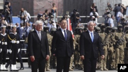 U.S. Vice President Mike Pence, right, Polish President Andrzej Duda, center and German President Frank-Walter Steinmeier stand during a memorial ceremony marking the 80th anniversary of the start of World War II in Warsaw, Poland, Sept. 1, 2019.