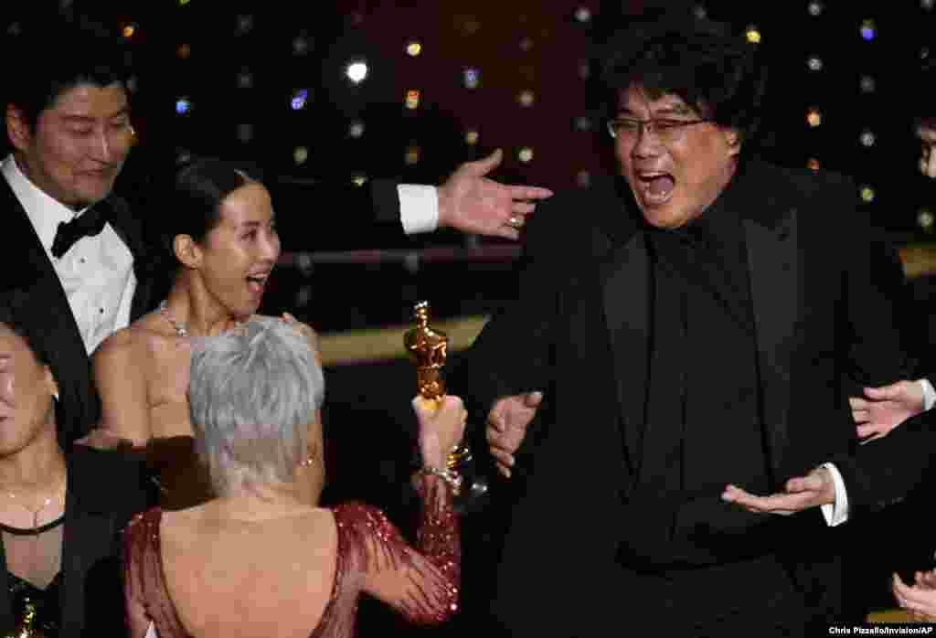 Bong Joon Ho, right, reacts as he is presented with the award for best picture for &quot;Parasite&quot; from presenter Jane Fonda at the Oscars, Feb. 9, 2020, at the Dolby Theatre in Los Angeles, California.
