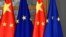 FILE - European Union and Chinese flags are displayed at the Europa building in Brussels, Dec. 17, 2019. 
