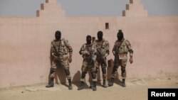 FILE - Pakistan Rangers prepare to take their positions during a counterterrorism training demonstration at the Rangers Shooting & Saddle Club on the outskirts of Karachi, Pakistan, Feb. 24, 2015.