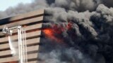 Firefighters try to douse the flames after a fire broke out in a commercial building at a textile market in Surat in the western Indian state of Gujarat. The cause of the fire is being investigated and no causality have been reported, fire officials said.