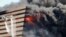 Firefighters try to douse the flames after a fire broke out in a commercial building at a textile market in Surat in the western Indian state of Gujarat. The cause of the fire is being investigated and no causality have been reported, fire officials said.