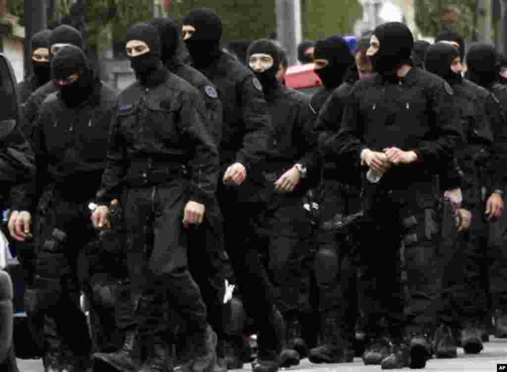 French special intervention police officers leave the area in Toulouse, France Thursday March 22, 2012 where an Islamic extremist died Thursday after jumping from his window, gun in hand, in a fierce shootout with police. The death of Mohamed Merah, 23, 