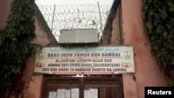 A sign is seen above a house where police rescued men and boys in Kaduna, Nigeria, Sept. 27, 2019. 