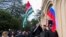 In this photo taken from video released by the AIASHARA Independent Agency, protesters gather around Abkhazian and Russian flags outside the parliament building of the Georgian separatist region of Abkhazia, Nov. 15, 2024.