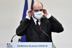 French Prime Minister Jean Castex adjusts his protective face mask during a press conference on the government's current strategy for the ongoing coronavirus pandemic in Paris, France, Feb. 25, 2021.