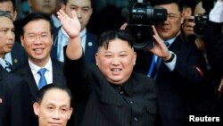 North Korean leader Kim Jong Un bids farewell to the crowd before boarding his train to depart for North Korea at Dong Dang railway station in Vietnam, March 2, 2019. 