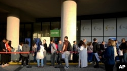 People wait for their turn at a visa application center, in Istanbul on November 3, 2023. (AP Photo/Emrah Gurel)