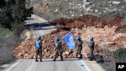 UN peacekeepers hold their flag in Blida, a Lebanese border village with Israel, in south Lebanon, Jan. 25, 2025. 