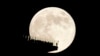 FILE - A supermoon rises behind an observation deck in New York City as seen from Hoboken, NJ, Nov. 15, 2024.