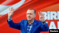 Turkey's President Tayyip Erdogan greets people at the United Solidarity and Brotherhood rally in Gaziantep, Turkey, Aug. 28, 2016. 