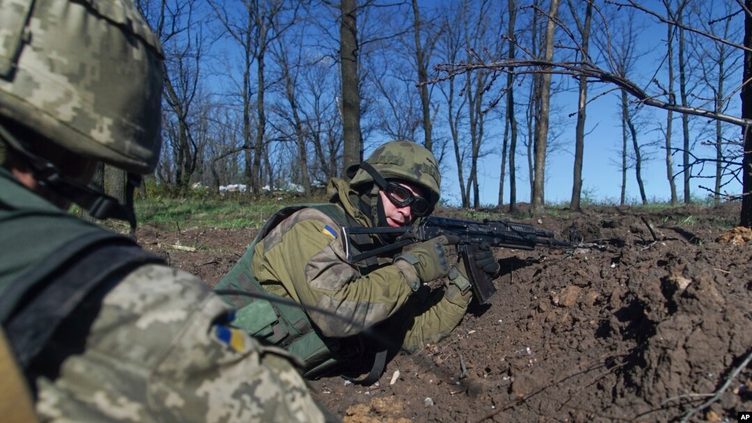 FILE - Ukrainian servicemen hold their position during a cease-fire outside Avdiivka, eastern Ukraine, April 16, 2016. 