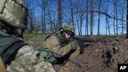 FILE - Ukrainian servicemen hold their position during a cease-fire outside Avdiivka, eastern Ukraine, April 16, 2016. 