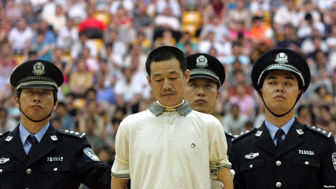 FILE - A drug dealer is sentenced to death by a judge during a public trial at a university gymnasium.