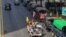 A vehicle with Myanmar and military flags and supporters of the Myanmar military and the military-backed Union Solidarity and Development Party passes by a row of police trucks with police security onboard parked near the Kyauktada police station in…