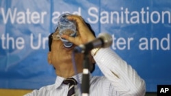 A Cambodian Municipality of Phnom Penh Deputy Governor Mann Chhoeun drinks water at the celebration of an annual World Water Day at Chroy Chang Va primary school in Phnom Penh, Cambodia, on Tuesday.