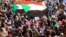 Sudanese protesters and wave flags during a rally at the Green Square in Khartoum, Sudan, July 18, 2019.