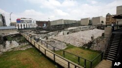 FILE - People visit the Templo Mayor in Mexico City, Oct. 3, 2006.