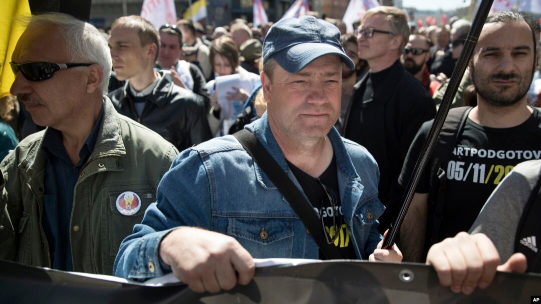 Ilya Osipov, center, attends an opposition rally in Moscow downtown, Russia, May 6, 2017. People gather for the rally against the Kremlin and demanding the release of political prisoners, five years since the opposition protest at May 6, 2012, that ended in violent clashes between demonstrators and police. 