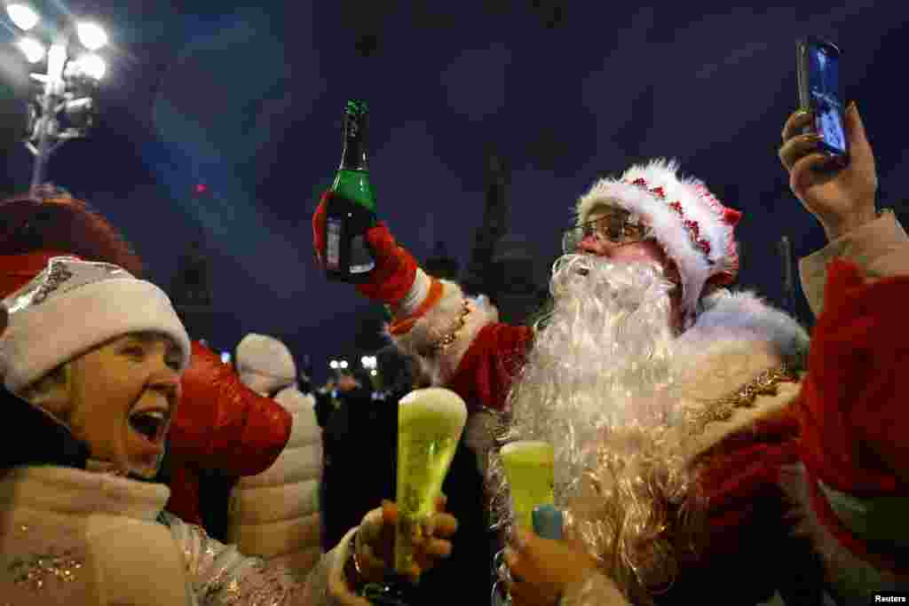 People cheer as they take part in New Year celebrations in central Moscow, Russia, Jan. 1, 2025.