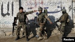 FILE - Afghan National Army (ANA) soldiers arrive after a blast near the Pakistani consulate in Jalalabad, Afghanistan, Jan. 13, 2016.