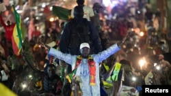 FILE—Presidential candidate Bassirou Diomaye Faye greets supporters after he was released from prison in Dakar, Senegal March 15, 2024.