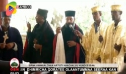 In this image taken from OBN video, the funeral for Ethiopia singer Hachalu Hundessa takes place in Ambo, Ethiopia, Thursday July 2, 2020.