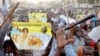 Disciples of Cheikh Béthio Thioune chant and carry clubs on a marchon March 17, 2012 in Dakar in support of President Abdoulaye Wade. They say the clubs were for self defense against anti-Wade activists.