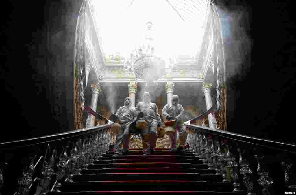 Workers in protective suits disinfect Dolmabahce Palace due to coronavirus concerns in Istanbul, Turkey, March 11, 2020.