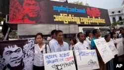 FILE - Activists hold placards during a protest against the killing of Aung Kyaw Naing, a freelance journalist, outside the city hall in Yangon, Myanmar. 