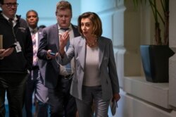 Speaker of the House Nancy Pelosi, D-Calif., walks to a meeting with her Democratic caucus as House moves toward passage of a coronavirus aid package on Capitol Hill in Washington, March 11, 2020.