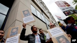 Orang-orang protes di depan sebuah pengadilan menuntut pembebasan wartawan Al-Jazeera, Ahmed Mansour di Berlin, Jerman, Minggu, 21 Juni 2015.