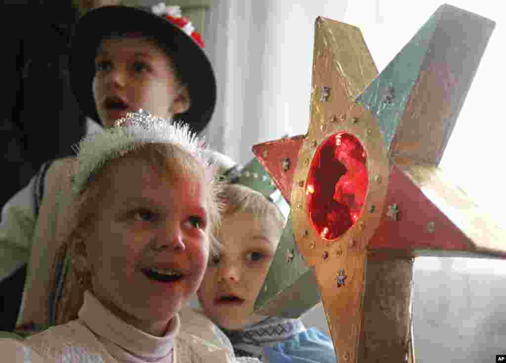 Children in traditional costumes sing Christmas carols, known locally as "Kolyadki" as they celebrate Orthodox Christmas in Pustomity village near Lviv, Urkaine, January 7, 2012. (Reuters)