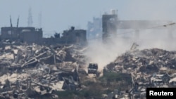 An Israeli military vehicle maneuvers in the Gaza Strip, amid the Israel-Hamas conflict, near the Israel-Gaza border, as seen from Israel, July 8, 2024.