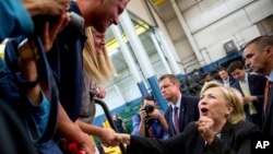 Democratic presidential candidate Hillary Clinton reacts while greeting supporters after giving a speech on the economy at Futuramic Tool & Engineering, in Warren, Mich., Aug. 11, 2016. 