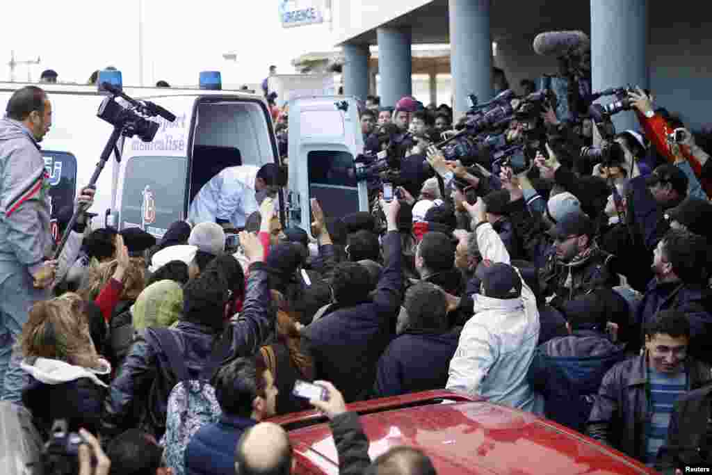 The body of Shokri Belaid, a prominent Tunisian opposition politician, is carried into an ambulance after he was shot, in Tunis.