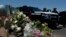 Flowers adorn a makeshift memorial near the scene of a mass shooting at a shopping complex in El Paso, Texas, Aug. 4, 2019.