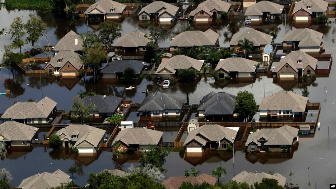 Homes are surrounded by water from the flooded Brazos River in the aftermath of Hurricane Harvey, in Freeport, Texas, Sept. 1, 2017.