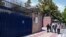 Pedestrians walk past the main gate of British Embassy in Tehran, Iran, Aug. 22, 2015. 