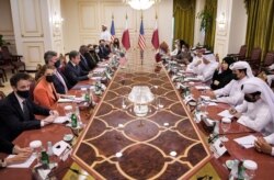 US Secretary of State Antony Blinken, fourth left and Secretary of Defense Lloyd Austin, fifth left, takes part in a meeting with Qatari counterparts in Doha, Qatar, Sept. 7, 2021.