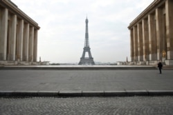 A police officer walks in the empty Trocadero square in Paris, France, March 18, 2020. President Emmanuel Macron said that for 15 days starting at noon on March 17, people will be allowed to leave the place they live only for necessary activities.