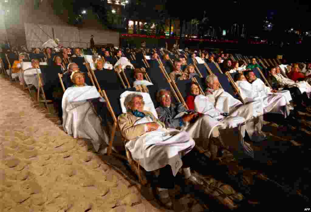 May 12: Spectators await the start of a beach front cinema screening on the Croisette during the 64th Cannes Film Festival. (REUTERS/Eric Gaillard)