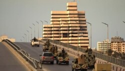 Fighters of a military battalion loyal to Libyan General Khalifa Hafta patrol the streets in the eastern city of Benghazi during a state of emergency to combat the coronavirus disease outbreak, March 21, 2020.