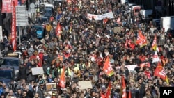 People march during a demonstration in Marseille, southern France, March 22, 2018.