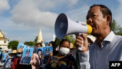  In this July 29, 2020, photo, Rong Chhun, president of Cambodia's Independent Teachers' Association, speaks at a factory workers' protest in Phnom Penh calling for benefits after their textile factory was shuttered amidst the coronavirus.