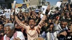 Yemeni anti-government protesters shout slogans during a demonstration demanding the resignation of President Ali Abdullah Saleh, in Sana'a, February 15, 2011