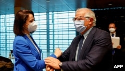 European Union Foreign Policy Chief Josep Borrell (R) greets Belarusian opposition leader Sviatlana Tsikhanouskaya prior to a EU foreign ministers meeting, in Luxembourg, June 21, 2021. 